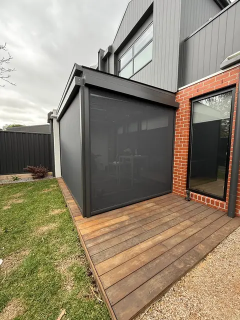 Charcoal privacy screen enclosing a timber deck