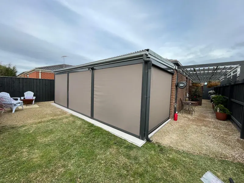 Grey outdoor screens fitted along a covered alfresco