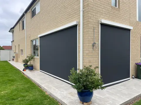 Outdoor blinds installed across townhouse balconies